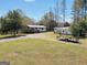 Exterior view of home with a long driveway, a building, and grassy yard at 509 Eskew Rd, Mcdonough, GA 30252