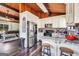 Bright kitchen featuring white cabinets, stainless steel appliances, and view to living room at 509 Eskew Rd, Mcdonough, GA 30252