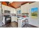 Stylish kitchen with white cabinets, stainless steel appliances, and convenient breakfast bar seating at 509 Eskew Rd, Mcdonough, GA 30252