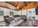 Spacious living room with a beamed ceiling, a sectional sofa, and natural light streaming in from windows at 509 Eskew Rd, Mcdonough, GA 30252