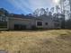 View of the rear exterior showing a screen door and a natural lawn at 5802 Bay Pointe Sound Nw, Acworth, GA 30101