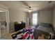 Cozy bedroom with a twin bed, dresser, and large window bringing in lots of natural light at 5802 Bay Pointe Sound Nw, Acworth, GA 30101
