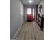Modern entryway with light wood flooring, a red front door, and stylish storage cabinet at 5802 Bay Pointe Sound Nw, Acworth, GA 30101