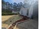 View of the side of the home with mulched beds and colorful flowers at 5802 Bay Pointe Sound Nw, Acworth, GA 30101