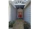 Charming front entrance with a red door and decorative plants at 5802 Bay Pointe Sound Nw, Acworth, GA 30101