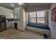 Bright kitchen with stainless appliances, white cabinets, built in bench and backyard view at 5802 Bay Pointe Sound Nw, Acworth, GA 30101