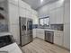 Modern kitchen features stainless steel appliances, white cabinets, and a farmhouse sink at 5802 Bay Pointe Sound Nw, Acworth, GA 30101