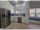 Bright kitchen with stainless appliances, white cabinets, built in bench and backyard view at 5802 Bay Pointe Sound Nw, Acworth, GA 30101
