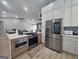 Open kitchen boasts stainless steel appliances, an island cooktop and a breakfast bar at 5802 Bay Pointe Sound Nw, Acworth, GA 30101