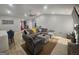 Relaxing living room featuring a comfortable gray sofa, ceiling fan, and light wood floors at 5802 Bay Pointe Sound Nw, Acworth, GA 30101
