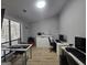 Well-lit home office with multiple work spaces, a large window, and light wood flooring at 5802 Bay Pointe Sound Nw, Acworth, GA 30101