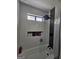 Contemporary shower design with built-in storage niches and sleek black fixtures at 5802 Bay Pointe Sound Nw, Acworth, GA 30101