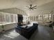 Relaxing sunroom with many windows, ceiling fan, mounted TV, brick fireplace and ample seating at 5802 Bay Pointe Sound Nw, Acworth, GA 30101