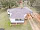 Overhead view of a cozy home, showcasing its carport, landscaping and backyard at 1202 Coan Dr, Locust Grove, GA 30248