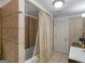 Bathroom with tiled shower, curtain, and door at 1202 Coan Dr, Locust Grove, GA 30248
