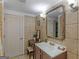 Tiled bathroom with large sink and mirror at 1202 Coan Dr, Locust Grove, GA 30248