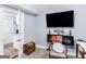 Bedroom featuring a wall-mounted TV, desk, and carpeted floors at 1202 Coan Dr, Locust Grove, GA 30248