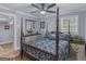 Comfortable bedroom with a bed, two end tables, and ceiling fan at 1202 Coan Dr, Locust Grove, GA 30248