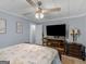 Relaxing bedroom with tv and ceiling fan at 1202 Coan Dr, Locust Grove, GA 30248