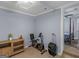 Cozy bedroom area offering access to additional rooms and complete with an exercise bike at 1202 Coan Dr, Locust Grove, GA 30248