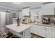 Modern kitchen with white cabinets, granite countertops, and stainless steel appliances at 1202 Coan Dr, Locust Grove, GA 30248