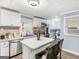 Bright kitchen with white cabinets, stainless steel appliances, and a central island at 1202 Coan Dr, Locust Grove, GA 30248