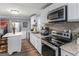 Kitchen area showcasing stainless steel appliances, countertop space, and white cabinets at 1202 Coan Dr, Locust Grove, GA 30248