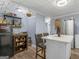 Kitchen view showcasing its stylish island, refrigerator, and charming decor at 1202 Coan Dr, Locust Grove, GA 30248