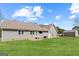 Large backyard with a gray house, green grass, shed, and blue skies at 280 Nutt Dr, Locust Grove, GA 30248
