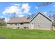 Backyard featuring a large, well-maintained lawn and gray house with green grass at 280 Nutt Dr, Locust Grove, GA 30248