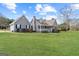 Charming single-Gathering home with gray siding, well manicured green lawn and tall trees at 280 Nutt Dr, Locust Grove, GA 30248