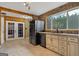 Kitchen with stainless steel appliances, tile flooring, stone backsplash, and an open doorway to the backyard at 280 Nutt Dr, Locust Grove, GA 30248