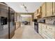 Spacious kitchen with stainless steel appliances, stone accents, white cabinetry, and tile flooring at 280 Nutt Dr, Locust Grove, GA 30248