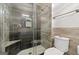 Shower featuring dark tiles, a glass enclosure, a handheld shower head, and new fixtures at 280 Nutt Dr, Locust Grove, GA 30248