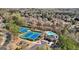 Aerial view highlights community tennis courts, pool, and clubhouse among tree-lined streets at 3149 Hidden Falls Ne Dr, Buford, GA 30519