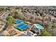 An aerial shot showcasing tennis courts, a pool, and clubhouse within a lush community at 3149 Hidden Falls Ne Dr, Buford, GA 30519