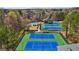 An overhead photo showing community tennis courts and pool among mature trees at 3149 Hidden Falls Ne Dr, Buford, GA 30519
