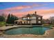 Luxurious backyard with a large in-ground pool and a covered patio perfect for outdoor relaxation at 3149 Hidden Falls Ne Dr, Buford, GA 30519