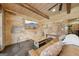 Cozy basement with leather sofa, coffee table, and brick accents at 3149 Hidden Falls Ne Dr, Buford, GA 30519