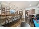 Basement bar area with stone counter, bar stools, and TV at 3149 Hidden Falls Ne Dr, Buford, GA 30519