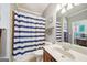 Bathroom with blue and white striped shower curtain at 3149 Hidden Falls Ne Dr, Buford, GA 30519