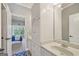 Bathroom with vanity and ample white cabinet storage, tile flooring, and a bedroom view at 3149 Hidden Falls Ne Dr, Buford, GA 30519