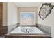 Bathtub with decorative window and tile surround at 3149 Hidden Falls Ne Dr, Buford, GA 30519