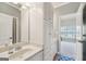 Bright bathroom featuring vanity with cabinet storage and a doorway view into the bedroom at 3149 Hidden Falls Ne Dr, Buford, GA 30519