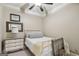Cozy bedroom with a white iron bed frame, dresser, mirror and soft, neutral decor at 3149 Hidden Falls Ne Dr, Buford, GA 30519