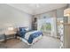 Serene bedroom with tray ceiling, a plush bed, a large window, and soft, neutral colors at 3149 Hidden Falls Ne Dr, Buford, GA 30519