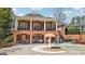 The community clubhouse features brick construction, a shaded seating area and a wading pool at 3149 Hidden Falls Ne Dr, Buford, GA 30519
