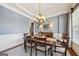 Well-lit dining room featuring classic wainscoting and an elegant chandelier above a wooden table at 3149 Hidden Falls Ne Dr, Buford, GA 30519