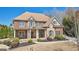 Attractive two-story brick residence featuring stone accents, a cozy front porch, and lush landscaping at 3149 Hidden Falls Ne Dr, Buford, GA 30519