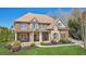 Charming two-story brick and stone home with manicured landscaping, a welcoming front porch, and excellent curb appeal at 3149 Hidden Falls Ne Dr, Buford, GA 30519